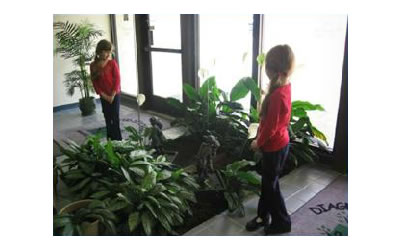 Katie looks at her reflection in the mirror at the entrance of the DCC.