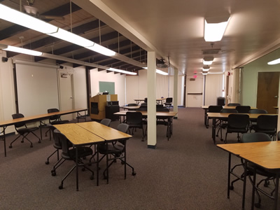 Large open room with several sets of tables and chairs.