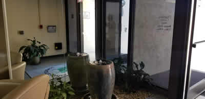 Bubbling water fountain displayed in front of a wall mirror.